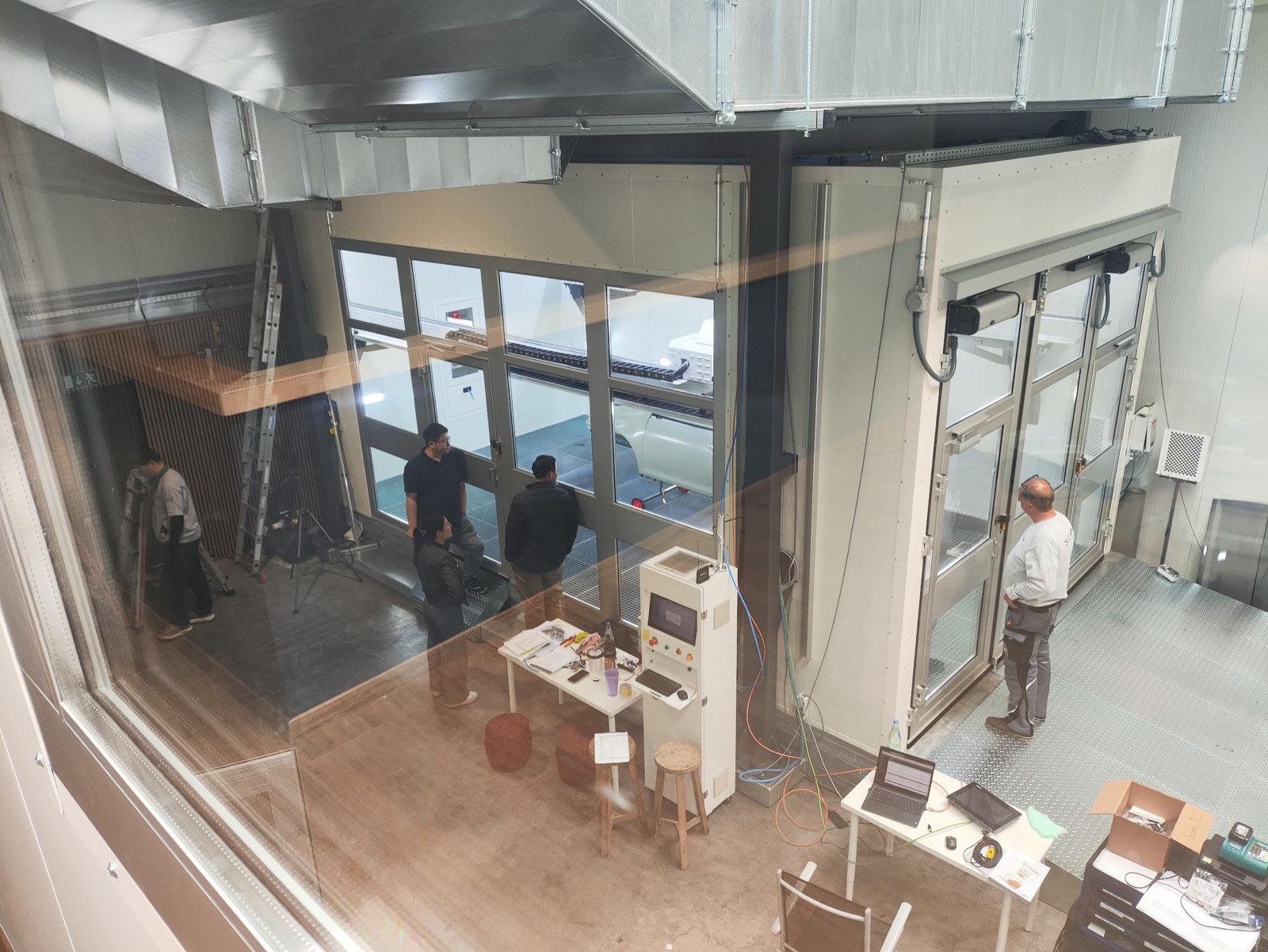 Overhead view of the custom SEHON spray booth with the NST gantry system during commissioning