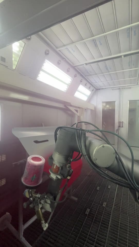 The NST robot repainting a car door from white to red