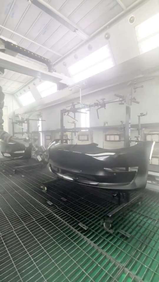 The NST robot spraying a row of car parts