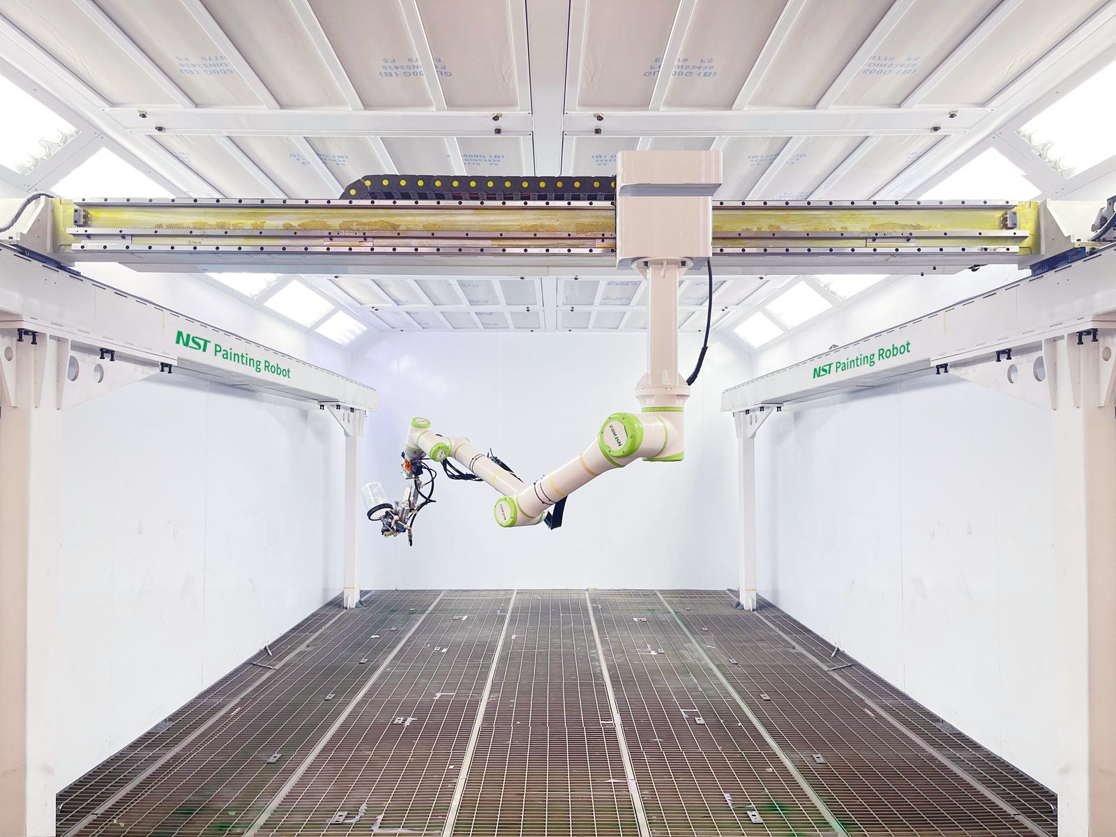 The 9-axis NST arm reaching down inside the spray booth